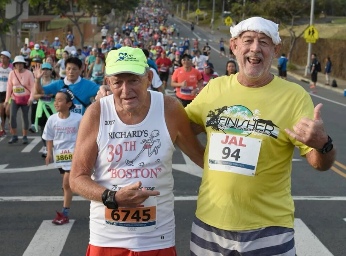 Gary Dill (right) with Richard Carling on the course of the 2017 Honolulu Marathon