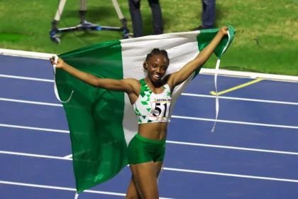 Ruth Usoro of Nigeria celebrates her gold medal at the triple jump
