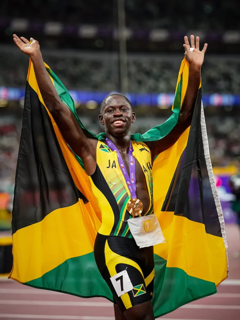 Oblique Seville celebrates after his 100m win at Tokyo 25