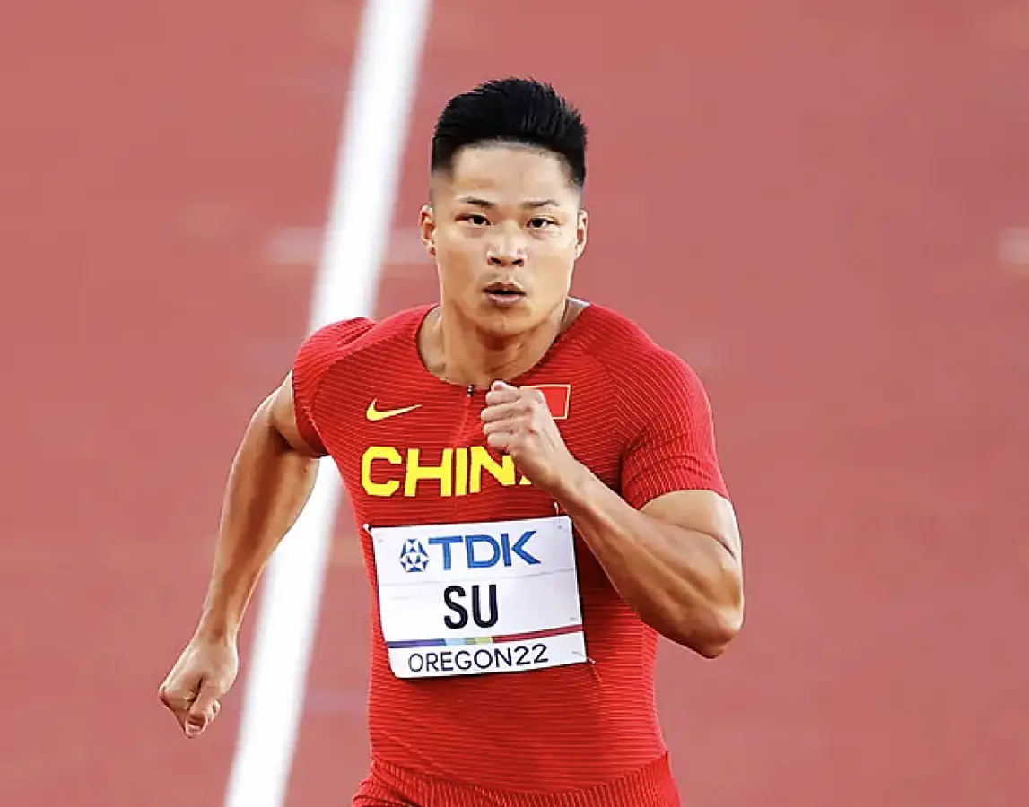 Chinese sprinter Su Bingtian (center) competing in the 100 meters.