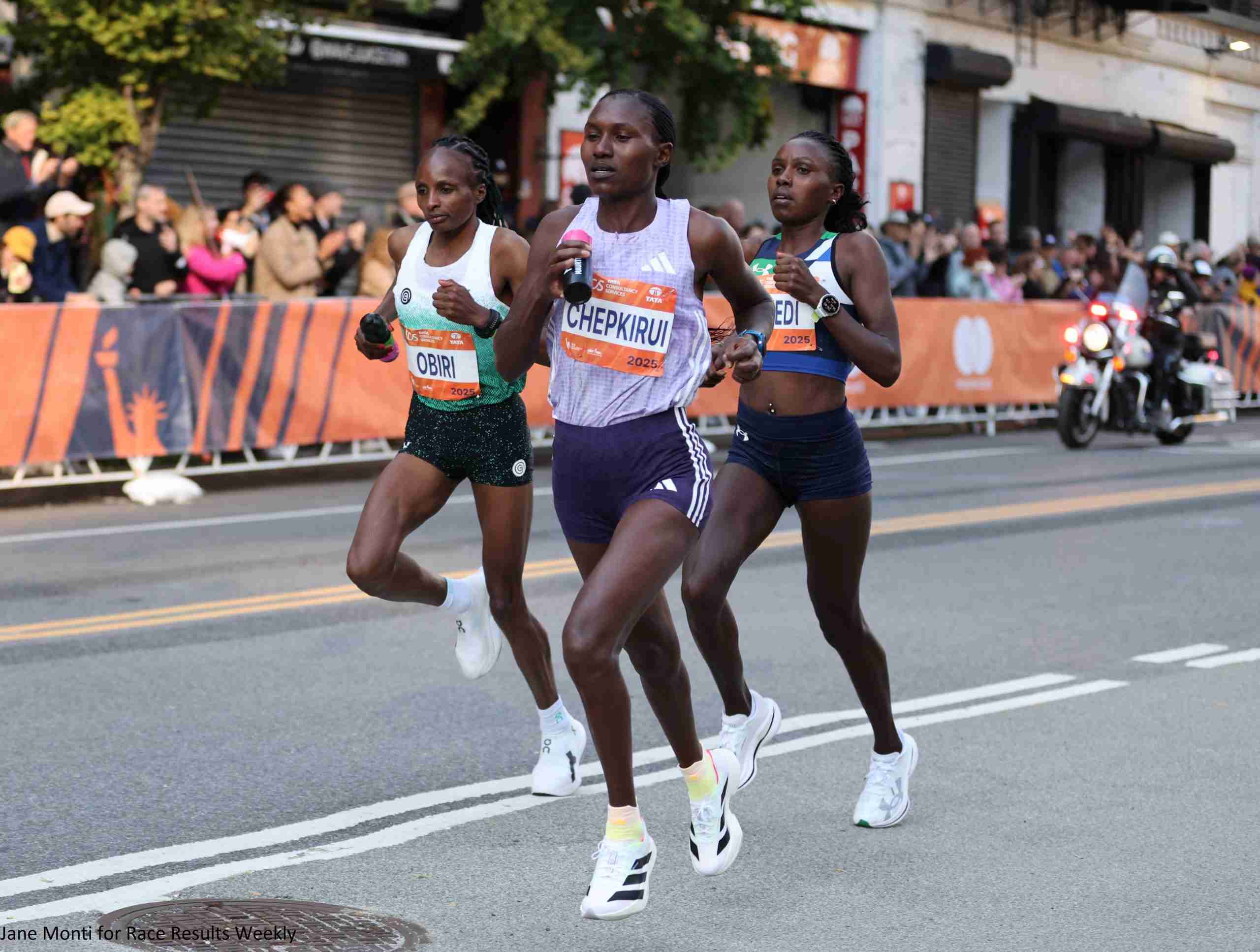 Hellen Obiri, Sharon Lokedi and Sheila Chepkirui after descending the Queensboro Bridge in the 17th mile of the 2025 TCS New York City Marathon