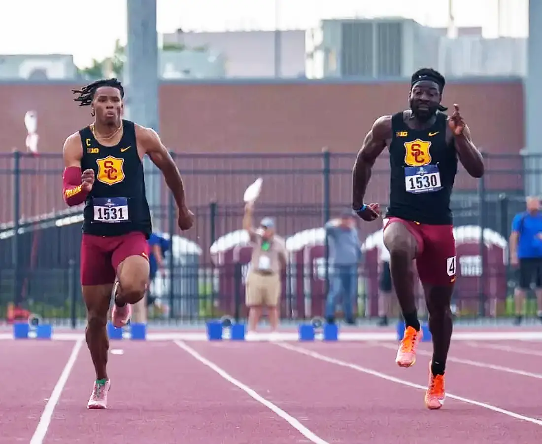 Eddie Osei-Nketia (R) completes in the men's 100m for USC.